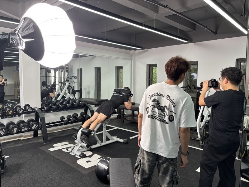 Photographer capturing a model using fitness equipment during a China product shoot